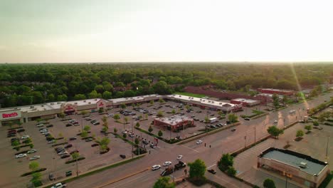 Aerial-view-of-Arlington-Heights,-Illinois-highlighting-a-commercial-shopping-center,-parking-lot,-and-tree-filled-residential-areas