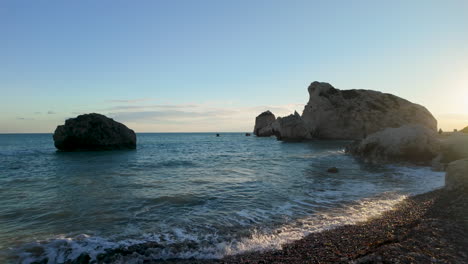 A-serene-coastal-scene-at-sunset-featuring-the-famous-Aphrodite's-Rock-in-Pafos,-Cyprus