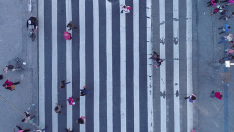 Aerial-view-of-people-crossing-a-large-crosswalk,-Sao-Paulo,-Brazil