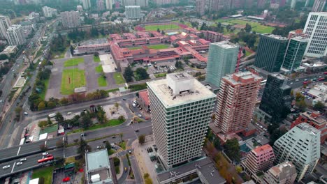 Aerial-drone-fly-above-high-traffic-buildings,-Santiago-de-Chile-vibrant-capital