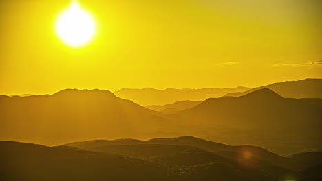 Mountains-in-Greece-during-a-fiery,-golden-sunset-time-lapse