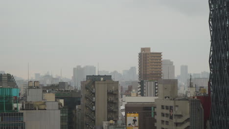 City-skyline-on-a-cloudy-and-wet-day-in-Ikebukuro,-Tokyo