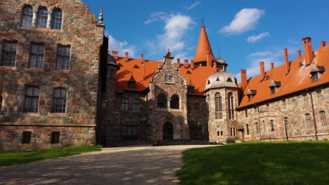 Establishing-shot-of-Cesvaine-medieval-castle-on-a-sunny-summer-day-with-blue-sky-above