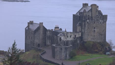 Slow-panning-shot-of-rain-falling-down-on-the-famous-Eilean-Donan-Castle