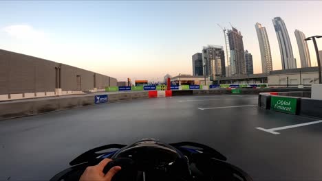 Man-enjoying-kart-racing-on-top-of-a-building-with-Burj-Khalifa-view