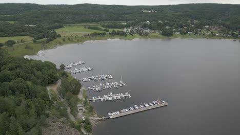 Flyover-small-marina-full-of-boats-on-lake-in-Scandinavia,-Sweden