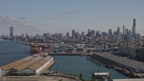 NYC-New-York-Aerial-v186-drone-flyover-Red-Hook,-Brooklyn-capturing-waterfront-shipyards-and-Manhattan-downtown-cityscape-across-East-river-in-the-daytime---Shot-with-Inspire-3-8k---September-2023