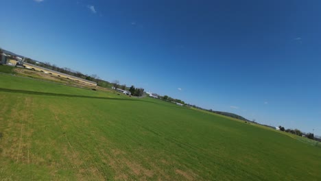 FPV-drone-flight-between-silo-storage-on-American-countryside-farm