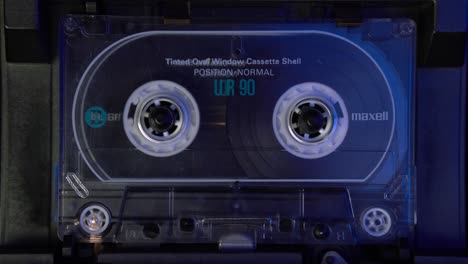 Close-Up-of-Audio-Cassette-Tape-Playing-in-Analog-Deck-Player