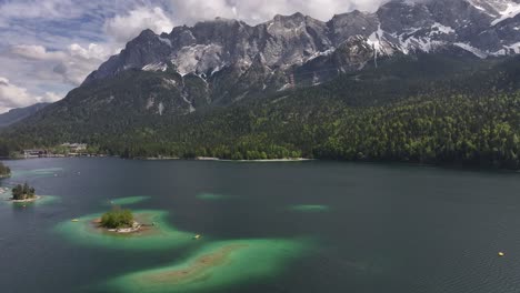 Aerial-above-Eibsee,-Grainau,-Germany,-against-a-stunning-mountainous-backdrop