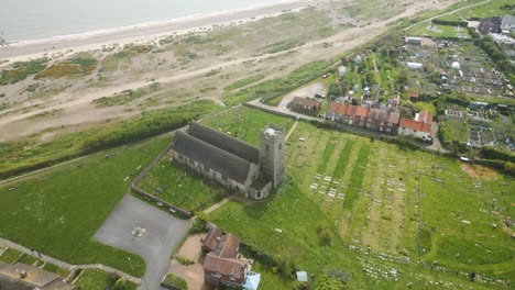 Aerial-pan-shot-of-Pakefield-Beach-Church-in-Lowestoft,-United-Kingdom