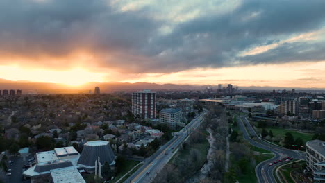 Sunset-aerial-over-Cherry-Creek-residential-district,-Denver-skyline-on-horizon