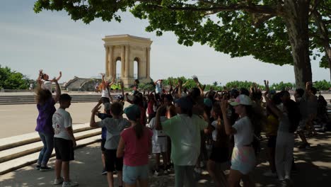 Slow-motion-shot-of-a-group-of-schoolchildren-dancing-with-teachers