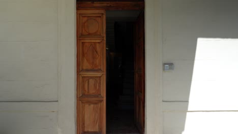 Slow-dolly-shot-towards-a-half-open-wooden-door-to-a-villa-in-Montpellier