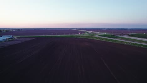 Aerial-of-tractor-plowing-field-at-dusk