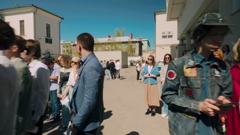 High-school-student-pupil-and-teacher-at-graduation-gathering-during-sunny-day-in-courtyard