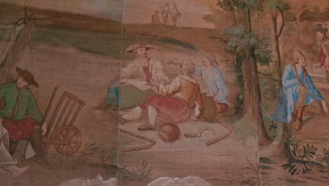 Intricate-wall-painting-depicting-a-lively-pastoral-scene-with-figures-in-traditional-attire