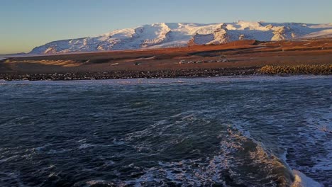 Islands-Malerische-Landschaft-Entlang-Der-Küste-Mit-Meereswellen-Und-Bergigem-Hintergrund