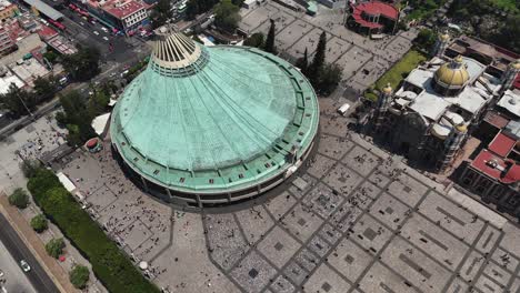 Aerial-view-of-roof-of-Basilica-of-Guadalupe,-due-to-its-circular-shape-and-green-color,-it-represents-a-mantle