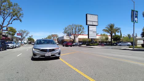 Sedan-Drives-Down-Busy-Street