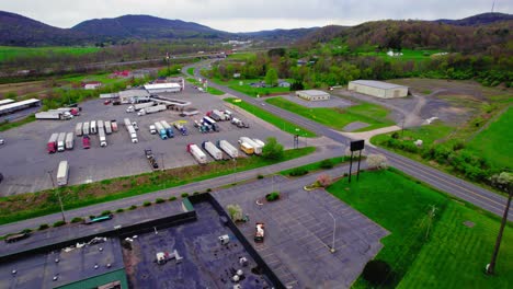 Aerial-view-of-a-busy-truck-stop-in-Milesburg,-PA-with-semi-trucks-and-trailers