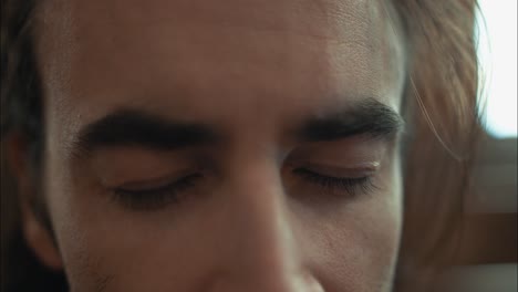 Closeup-of-eyes-of-emotional,-stressed-man-in-church-in-cinematic-slow-motion