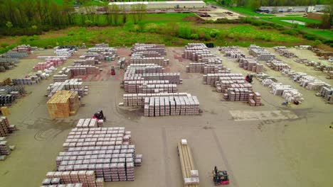 Forklifts-working-on-yard-with-stacks-of-Pavers-and-Slabs,-Permeable-and-Driveway-Pavers-in-Rittman,-Ohio,-USA