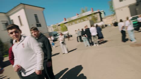 Boy-making-funny-face-towards-camera-during-high-school-graduation-event-steadicam-dutch-angle-movement