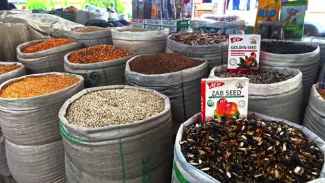 Assortment-od-healthy-seeds---sesame,-flax-seed,-sunflower-seeds,-pumpkin-seed,-chia-and-black-seed-in-bowls-on-a-black-stone-background-Video-Formats-4K