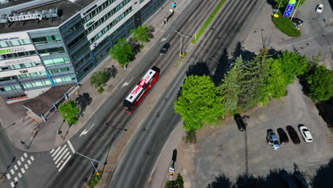 Aerial-tilt-shot-following-a-bus-on-the-streets-of-Tampere,-summer-day-in-Finland