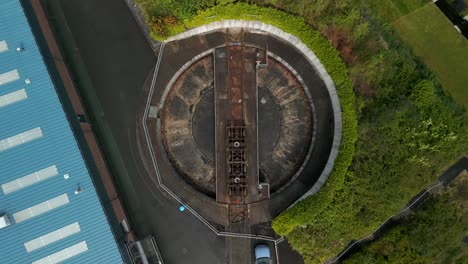 Flyover-of-a-train-turntable-at-Whitehead-Railway-Museum,-Northern-Ireland