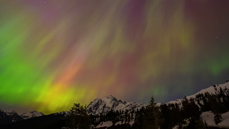 Timelapse-video-of-an-intense-G5-geomagnetic-storm-from-May-10,-2024,-triggers-stunning-multicolored-northern-lights-over-a-snow-covered-mountain,-visible-far-beyond-typical-latitudes