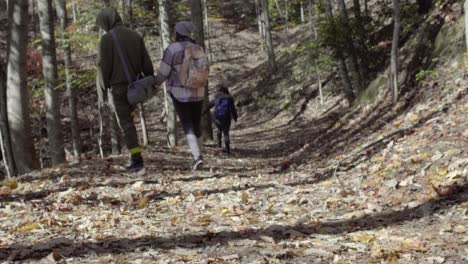 A-couple-walks-by-on-a-trail-in-fall