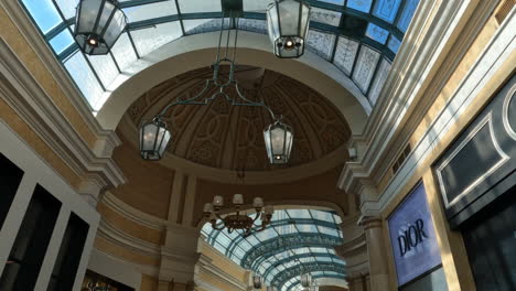 Vertical-Video,-Walking-in-Bellagio-Las-Vegas-Hallway-With-People-and-Upscale-Shops,-Nevada-USA