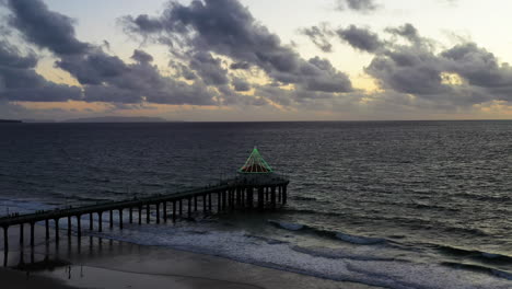 Manhattan-Beach-Pier-With-Christmas-Lights-In-California,-USA---Aerial-Drone-Shot