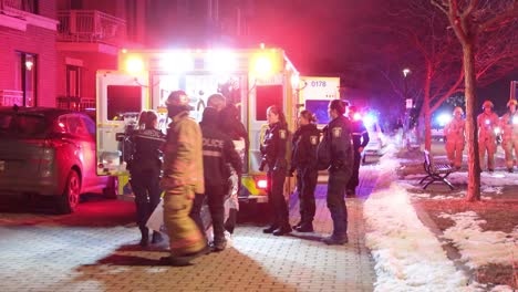 Policemen-Carrying-Hypothermia-Patient-Wrapped-In-Foil-Blanket-To-The-Ambulance-In-Montreal,-Canada