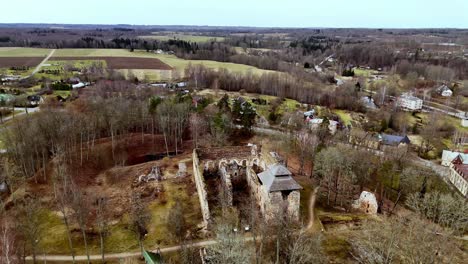 Revealing-shot-of-countryside-isolated-castle-ruins-north-european-rural-village