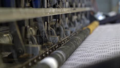 Machine-Making-a-Mattress-in-a-Factory,-Low-Angle-Close-Up-of-Production-in-Process