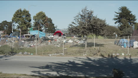 Wide-shot-of-a-homeless-camp-site-along-the-freeway-in-Berkeley,-California