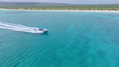 Aerial-tracking-shot-of-tourist-speedboat-on-turquoise-Caribbean-Sea-in-summer