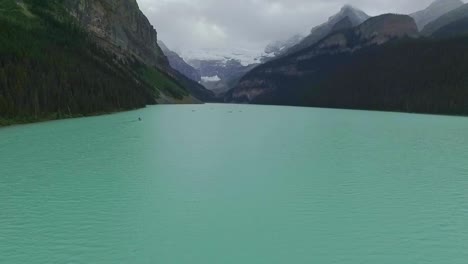 Aerial-Views-Over-Turquoise-Louise-Lake-in-Rockies-Mountains,-Banff-National-Park,-Alberta,-Canada