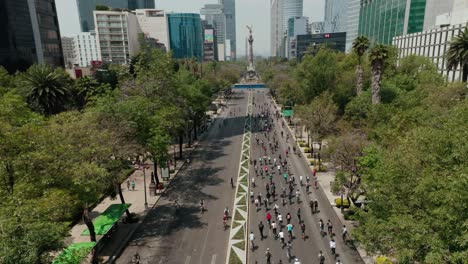 Drone-wide-angle-shot-above-bike-racing-marathon-at-reforma-at-day