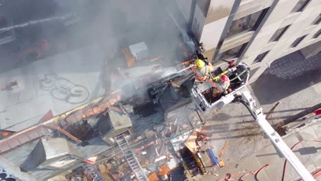 Firefighters-battling-a-blaze-in-montréal,-smoke-billowing,-cityscape,-aerial-view