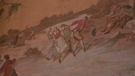 Vívido-Mural-Que-Representa-Una-Alegre-Escena-De-Baile-Al-Aire-Libre-Con-Figuras-Vestidas-Con-Trajes-Tradicionales,-El-Castillo-De-Trakoscan,-Croacia