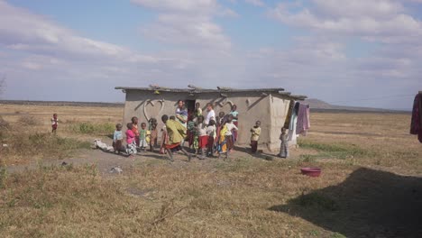 Two-white-caucasian-volunteers-surrounded-by-black-children-in-an-African-village-doing-humanitarian-work