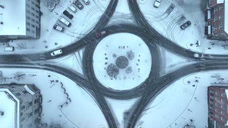 Snow-covered-town-square-with-roundabout-and-snowflakes-falling