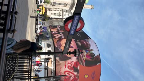 Vertical-video-of-Piccadilly-Circus-Underground-Station's-entrance-in-London,-England-On-Sunny-Morning