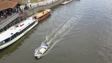 Aerial-of-small-boats-sailing-among-bigger-ones-in-Tigre,-Argentina