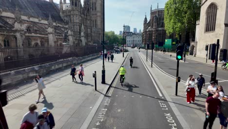 The-view-from-the-top-deck-of-a-bus-while-passing-the-Parliament-Building-in-London,-England