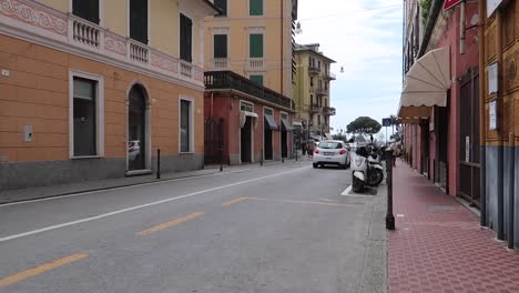 Cars-driving-down-narrow-road-in-Genoa-Italy-morning-commute